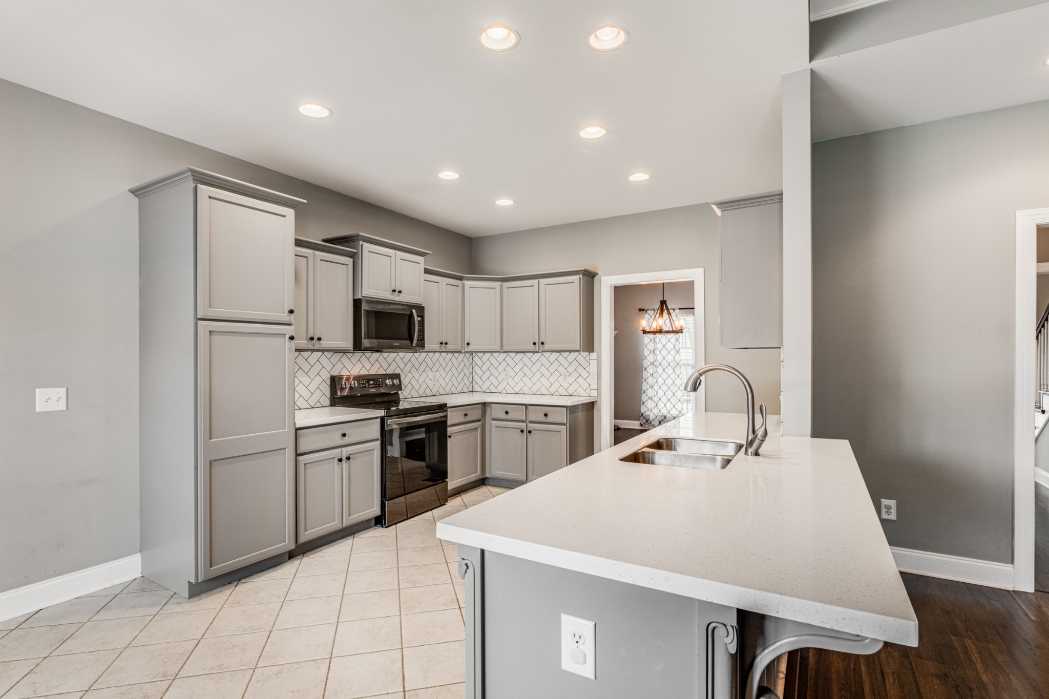 331 Midtown Trail Mount Juliet, TN 37122 - Photo 12 of 30 a large kitchen with kitchen island a stove a sink a refrigerator and a refrigerator