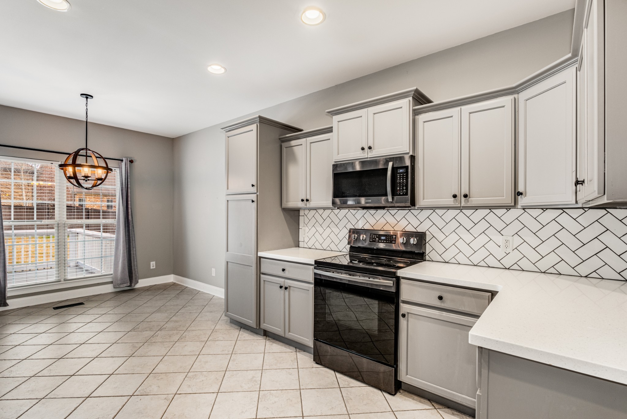 331 Midtown Trail Mount Juliet, TN 37122 - Photo 13 of 30 a kitchen with stainless steel appliances granite countertop a stove a sink and a microwave