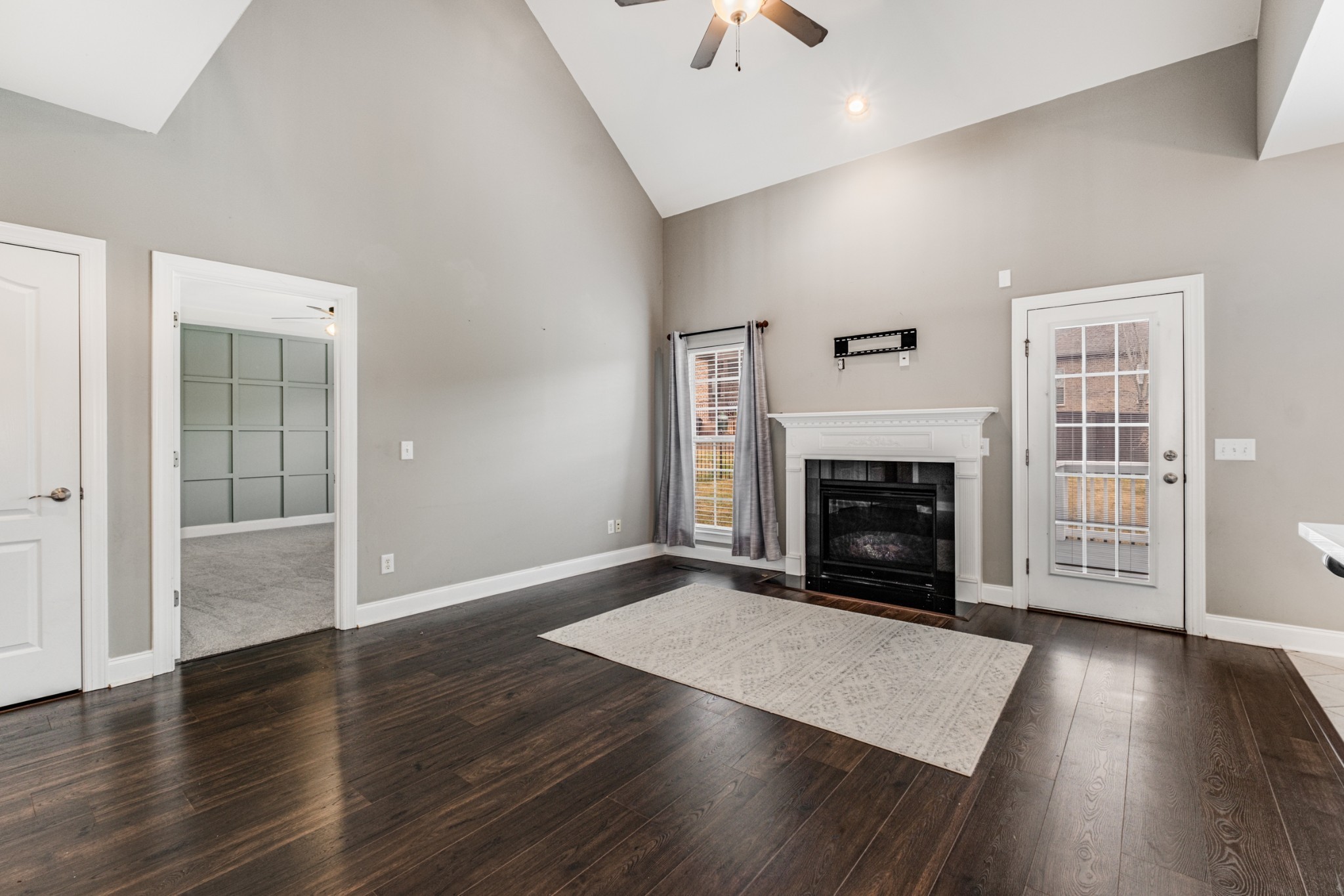 331 Midtown Trail Mount Juliet, TN 37122 - Photo 3 of 30 an empty room with wooden floor fireplace and windows