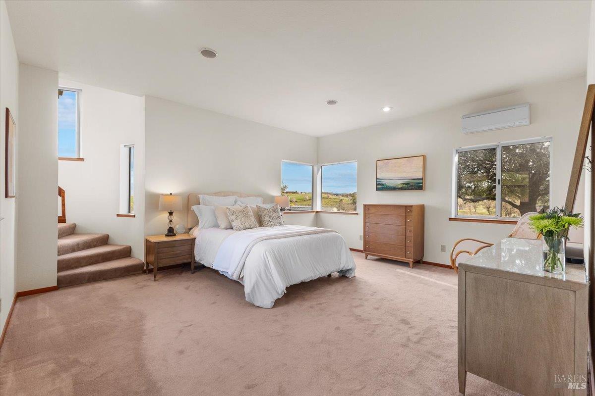 910-920 Lytton Springs Road Healdsburg, CA 95448 - Photo 18 of 59 a spacious bedroom with a bed and a couch