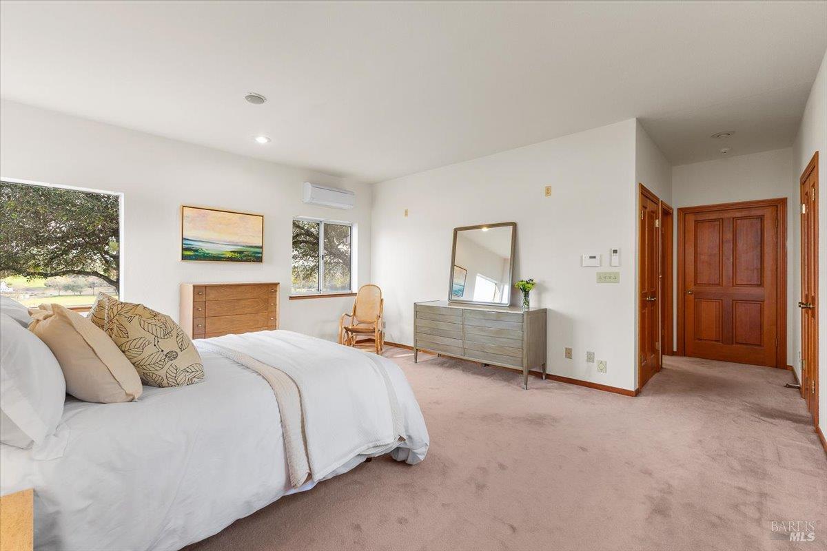 910-920 Lytton Springs Road Healdsburg, CA 95448 - Photo 20 of 59 a bedroom with a bed and a chandelier