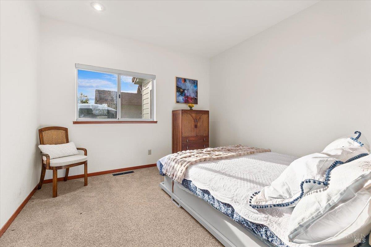 910-920 Lytton Springs Road Healdsburg, CA 95448 - Photo 35 of 59 a bedroom with a bed and a chair