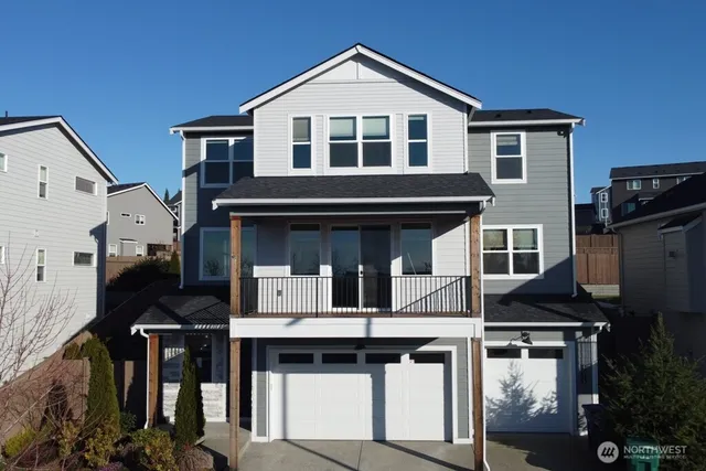 a front view of a house with barbeque and entryway