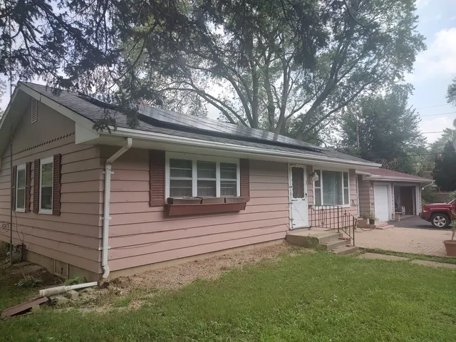 a backyard of a house with table and chairs