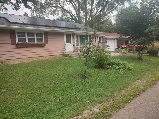 a front view of house with yard and green space