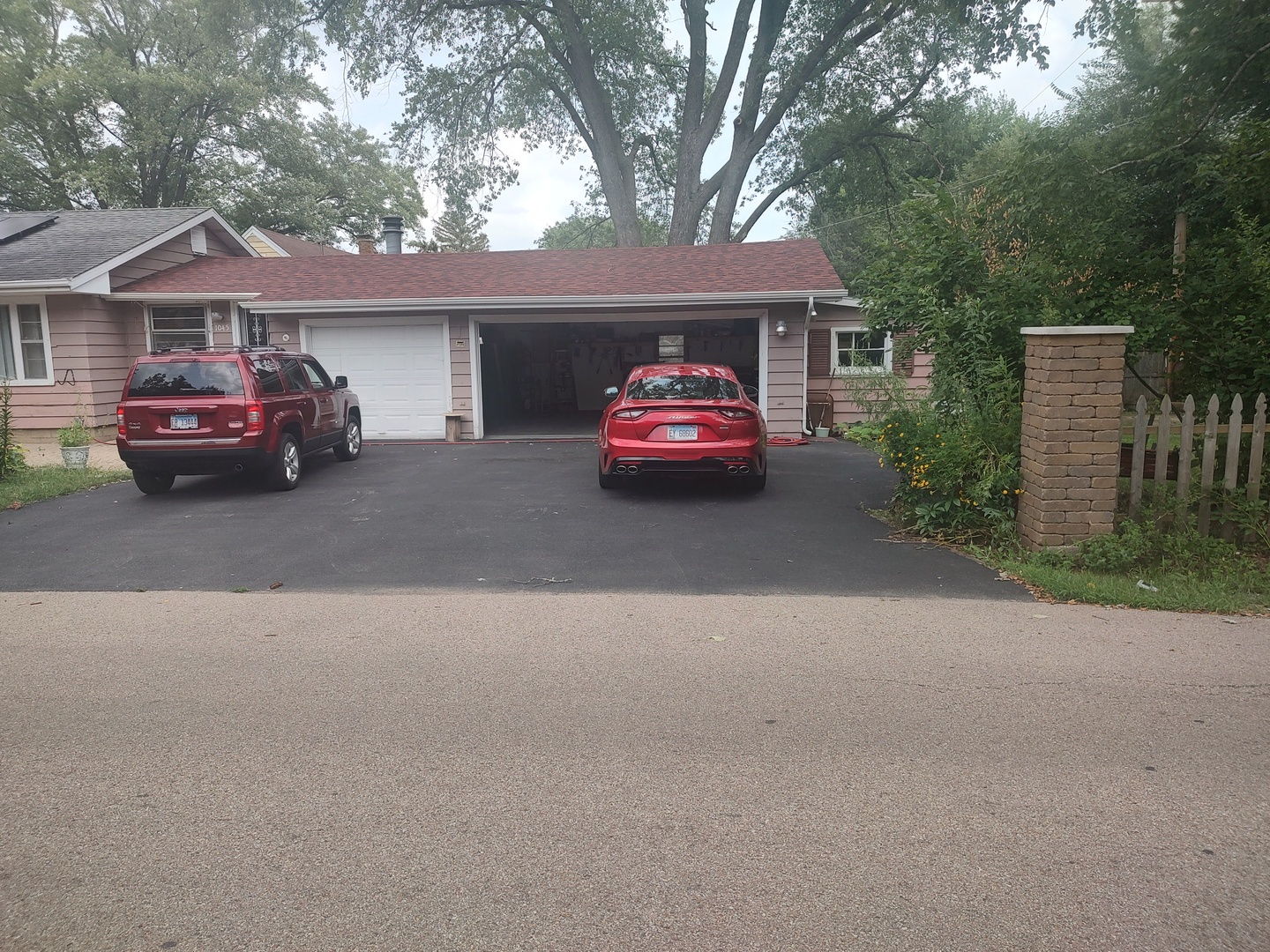 1045 Palace Street Aurora, IL 60506 - Photo 4 of 28 a front view of a house with a garden and parking