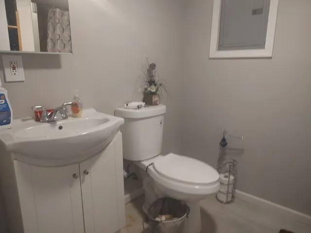 a bathroom with a sink a toilet and a mirror