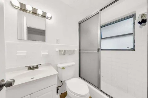 a white toilet sitting next to a bathroom sink