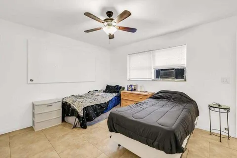 a bedroom with furniture and a large window