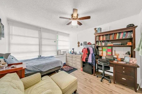 a bedroom with bed and a window