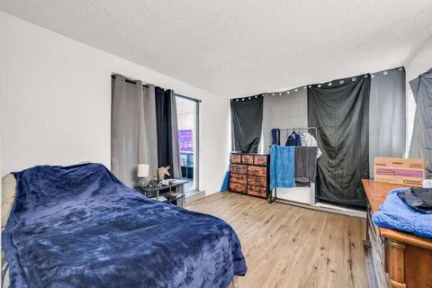 a bed room with a bed and a television