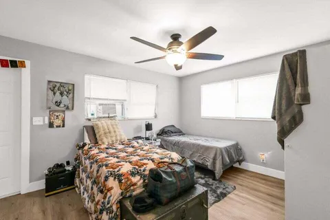 a bedroom with two beds and a window