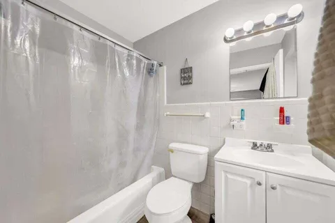 a bathroom with a sink mirror vanity and toilet