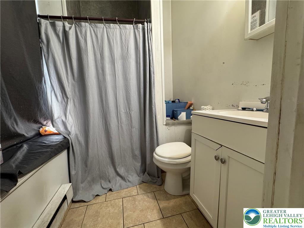 463 Montclair Avenue Bethlehem, PA 18015 - Photo 17 of 29 a bathroom with a toilet a sink and a mirror