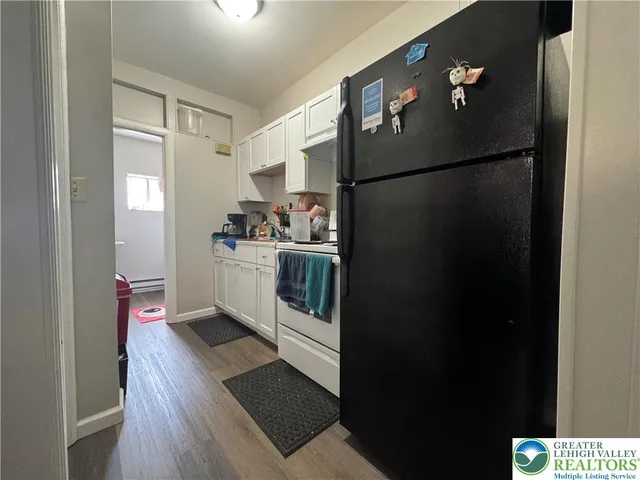 a kitchen with stainless steel appliances a refrigerator a sink a stove and cabinets