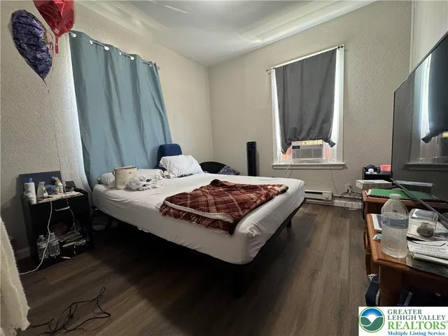 a bedroom with a bed and a flat screen tv