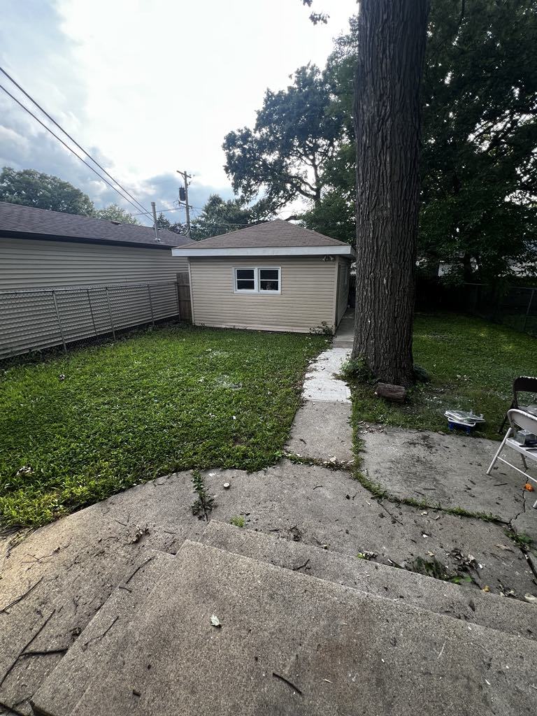 411 South May Street Joliet, IL 60436 - Photo 14 of 16 a view of a house with a yard