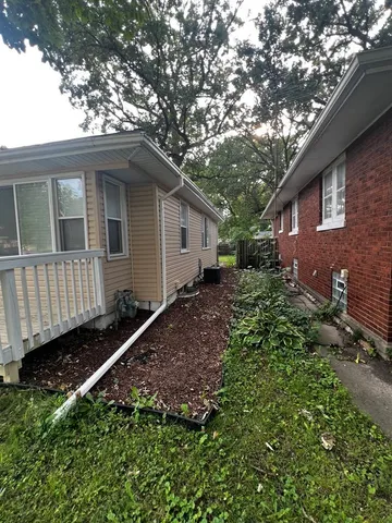a backyard of a house with table and chairs