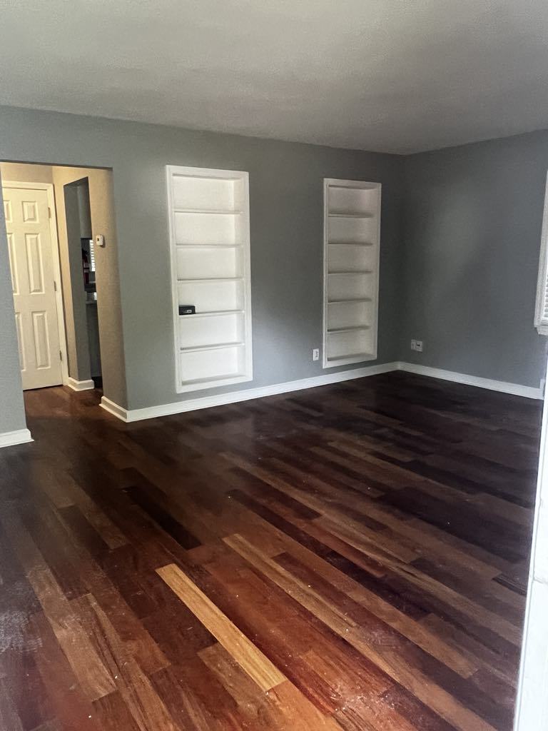 411 South May Street Joliet, IL 60436 - Photo 2 of 16 a view of empty room with wooden floor and fan