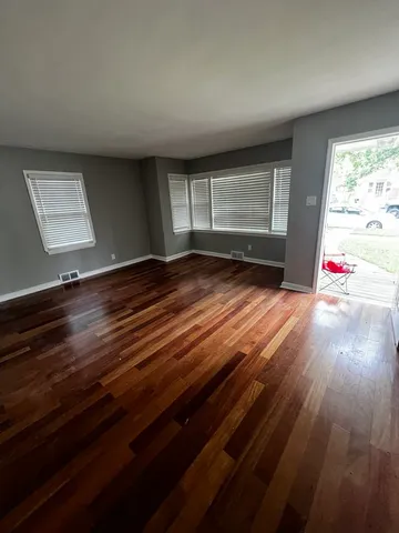 a kitchen with stainless steel appliances cabinets and wooden floor