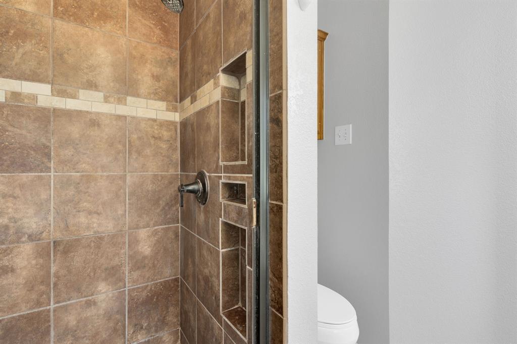 154 Richard Road Waxahachie, TX 75167 - Photo 13 of 38 a bathroom with a toilet and a shower