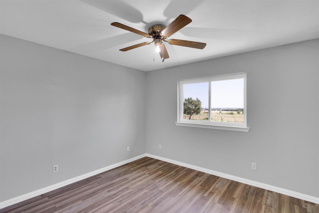 154 Richard Road Waxahachie, TX 75167 - Photo 17 of 38 wooden floor in an empty room with a window
