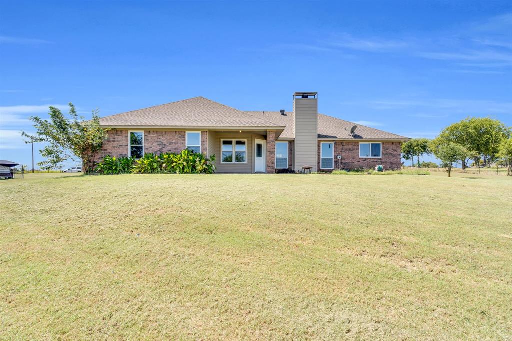 154 Richard Road Waxahachie, TX 75167 - Photo 7 of 38 a view of a patio with a table and chairs under an umbrella