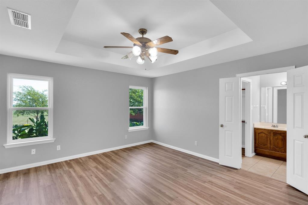 154 Richard Road Waxahachie, TX 75167 - Photo 8 of 38 a view of an empty room with wooden floor and a window