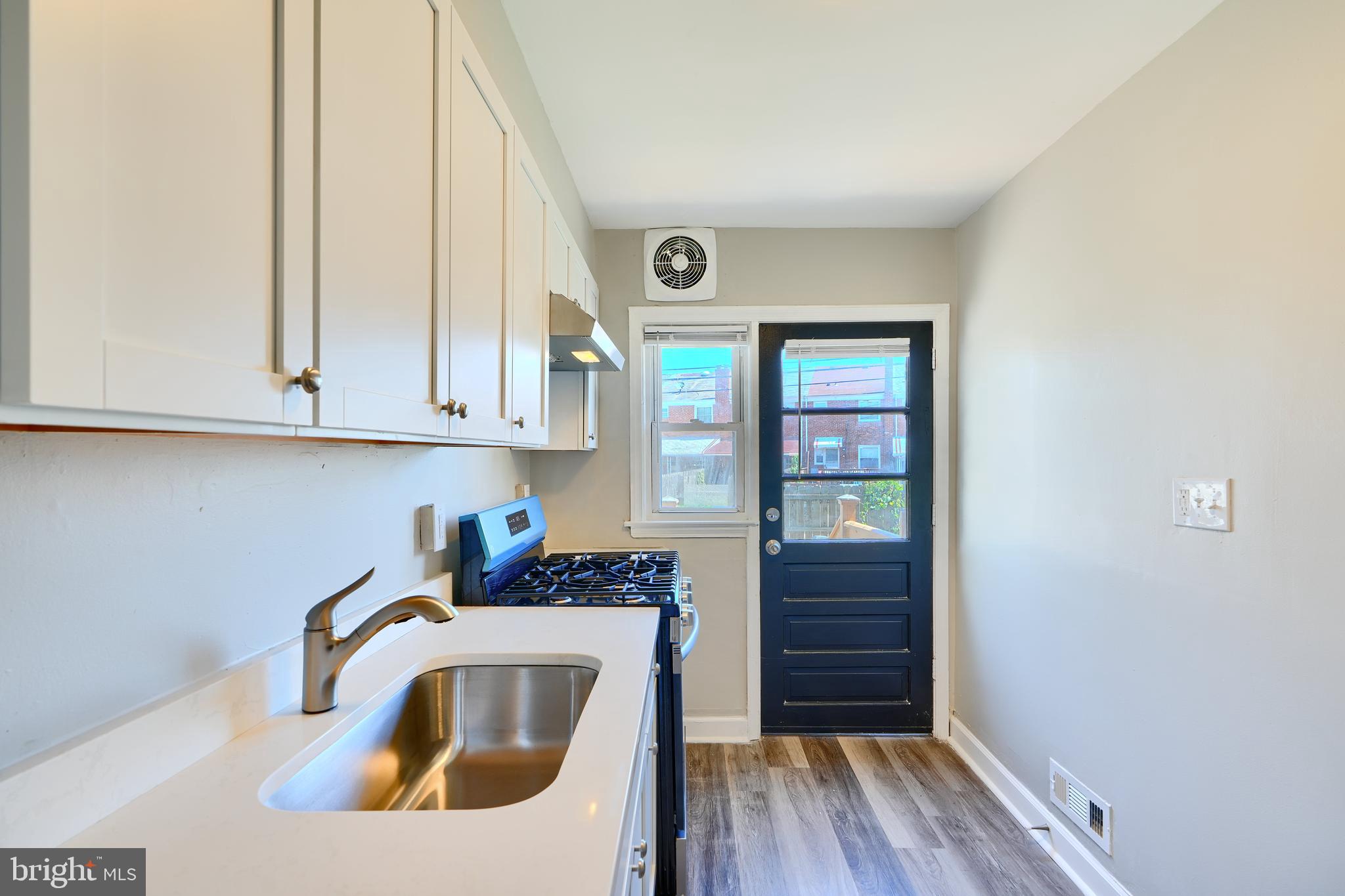 406 Torner Road Baltimore, MD 21221 - Photo 12 of 35 a kitchen with wooden floor and window