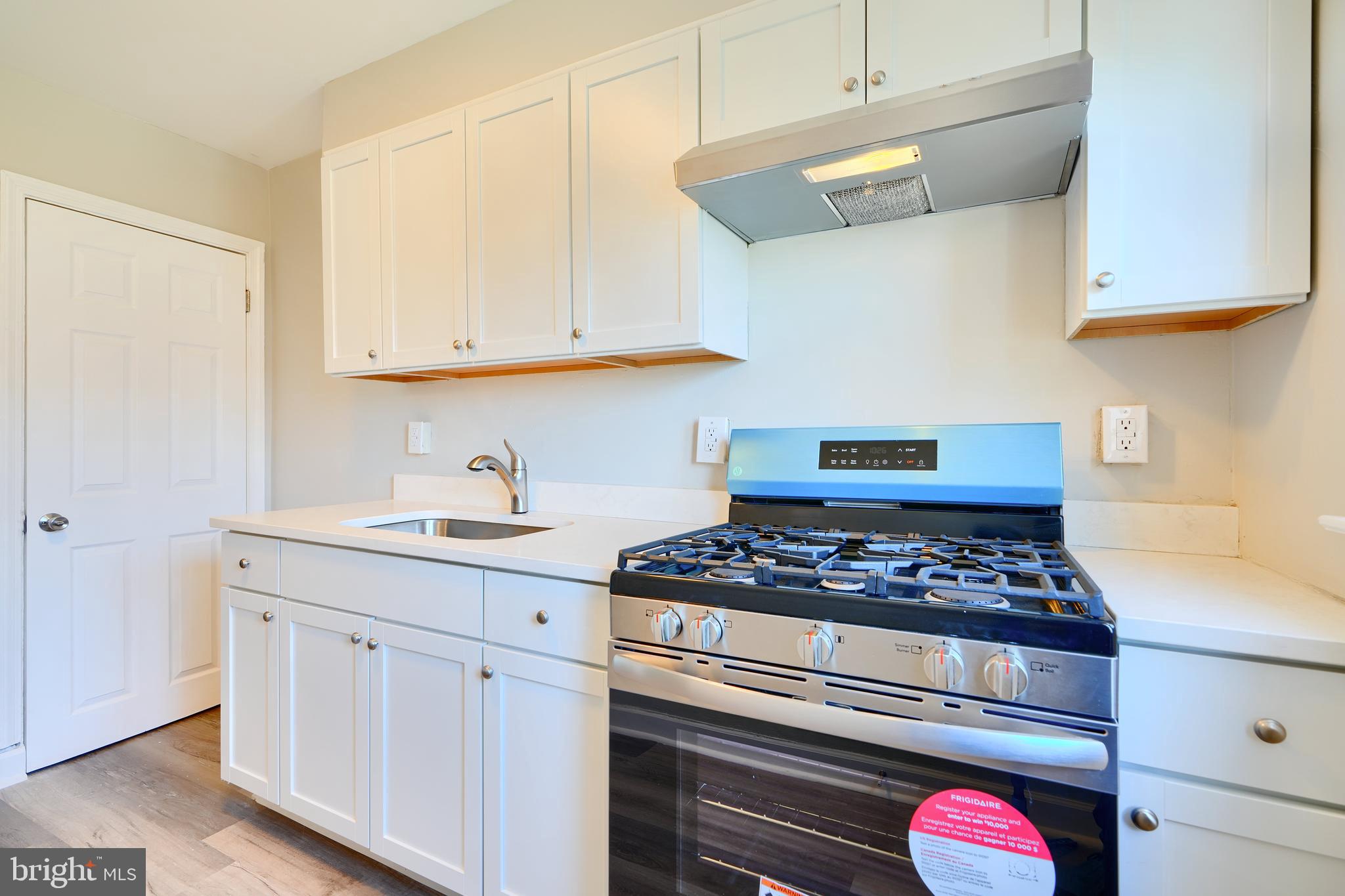406 Torner Road Baltimore, MD 21221 - Photo 13 of 35 a kitchen with white cabinets and appliances