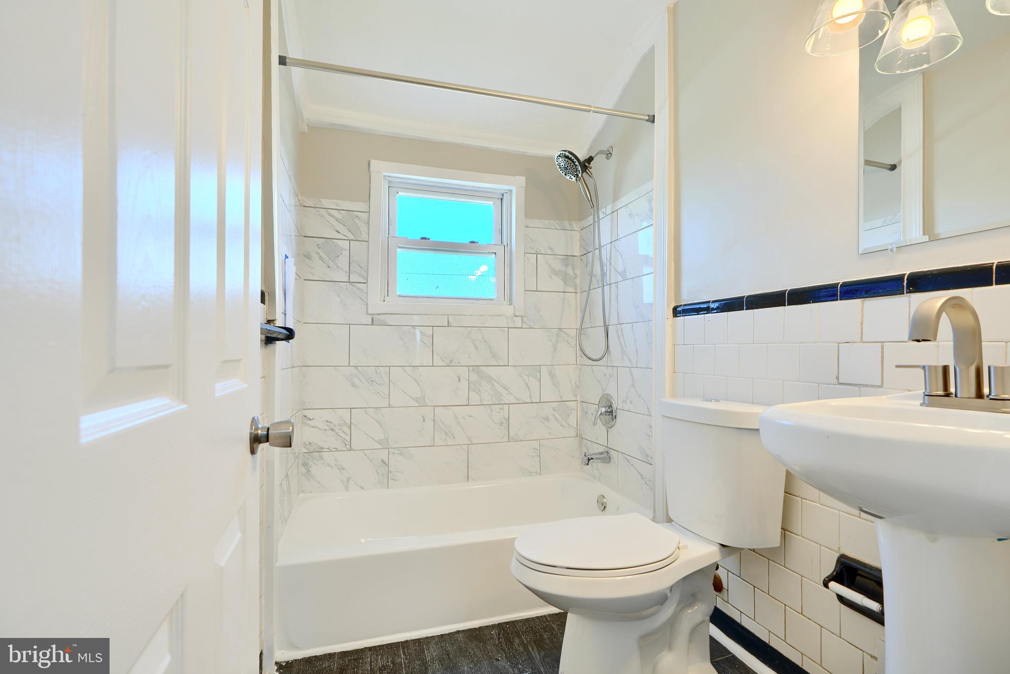 406 Torner Road Baltimore, MD 21221 - Photo 18 of 35 a bathroom with a sink toilet and shower