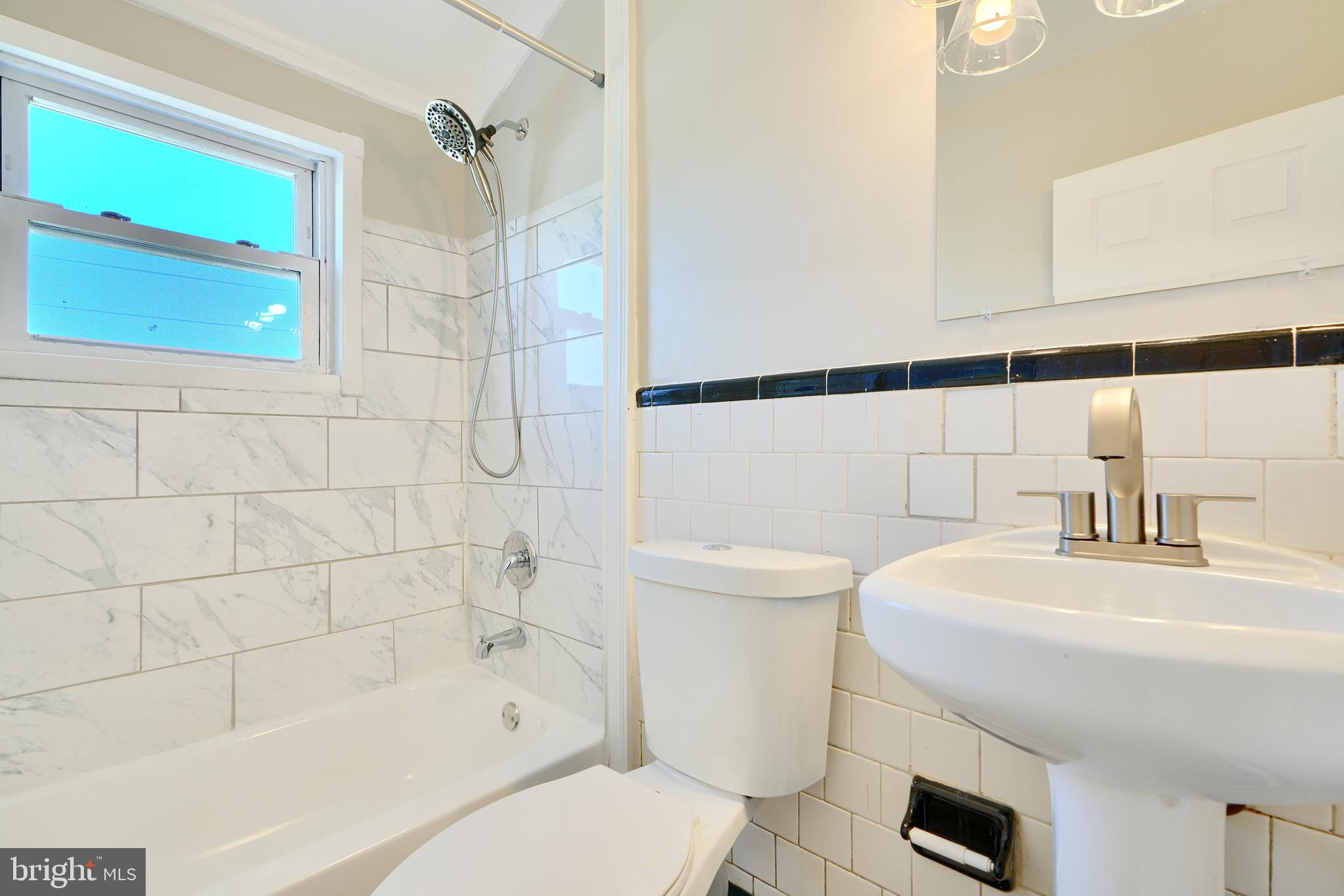 406 Torner Road Baltimore, MD 21221 - Photo 19 of 35 a bathroom with a sink a toilet and shower