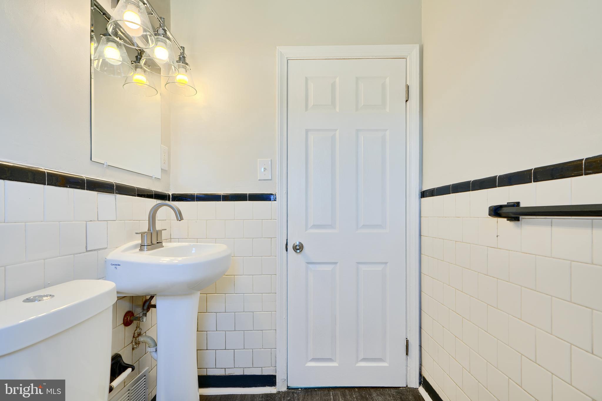 406 Torner Road Baltimore, MD 21221 - Photo 20 of 35 a bathroom with a sink a mirror and shower