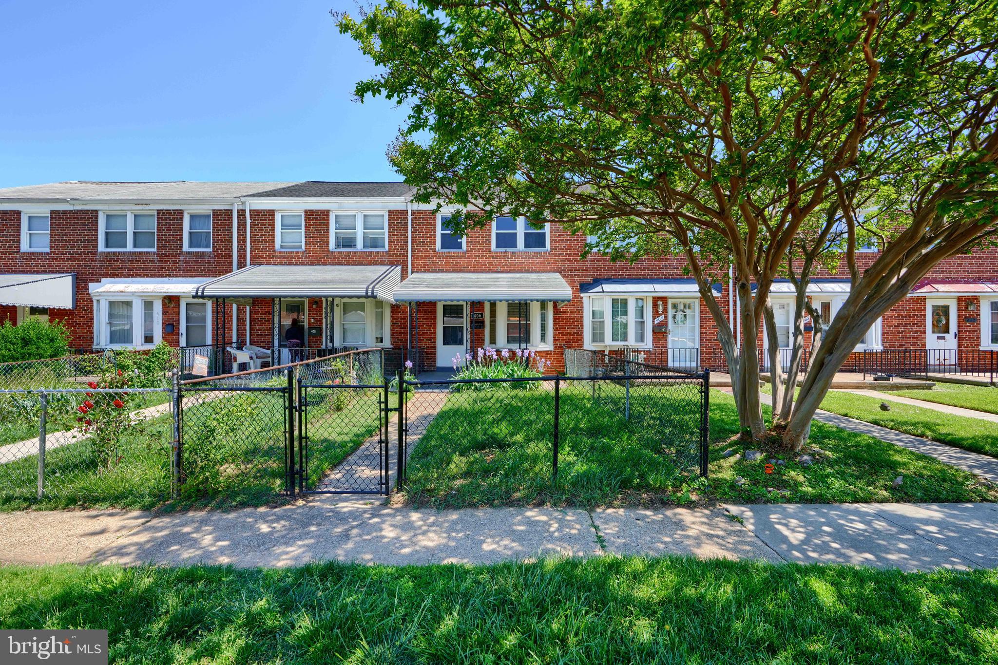 406 Torner Road Baltimore, MD 21221 - Photo 2 of 35 a front view of a house with a garden and trees