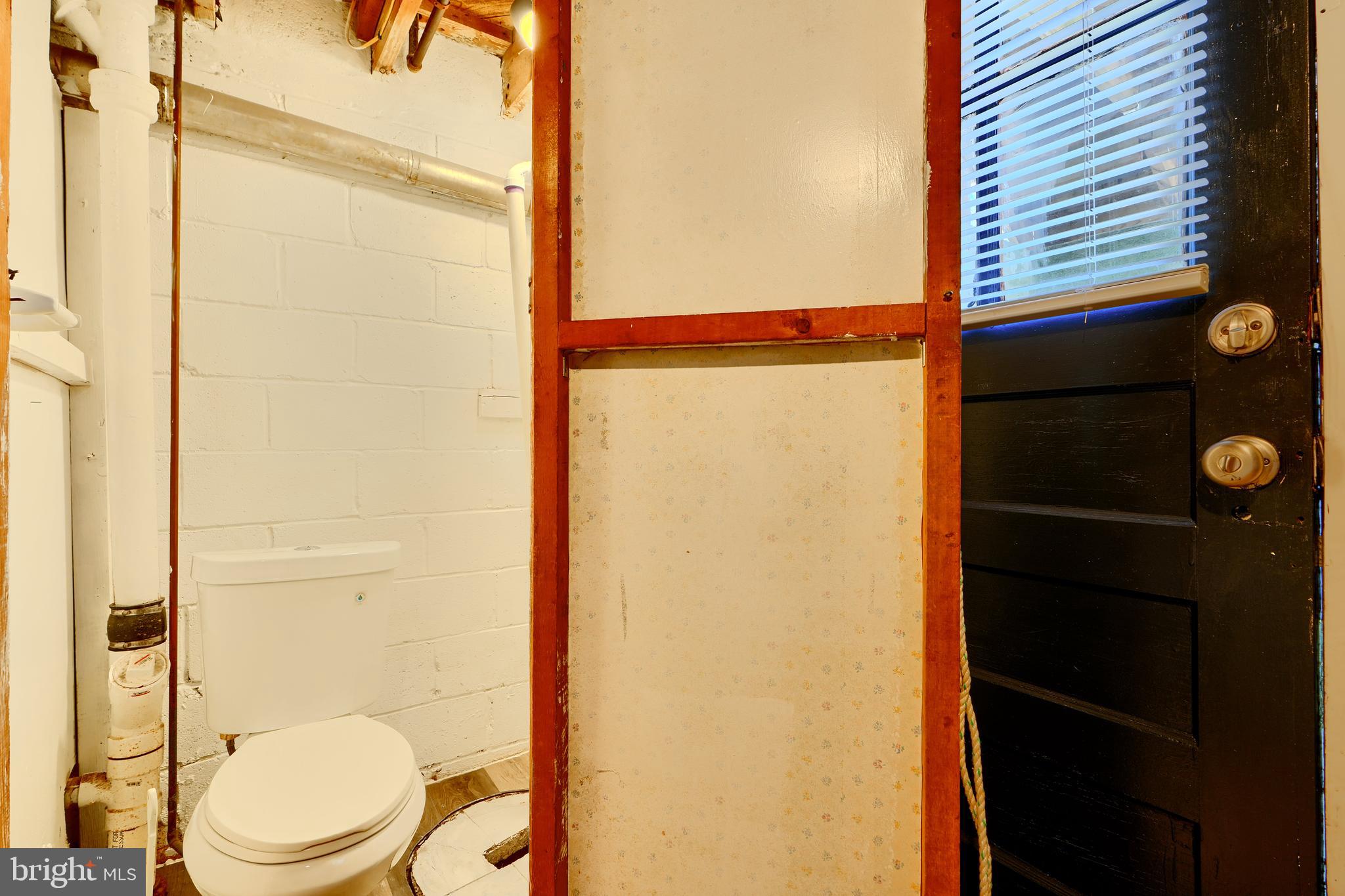 406 Torner Road Baltimore, MD 21221 - Photo 31 of 35 a bathroom with a toilet a sink and shower