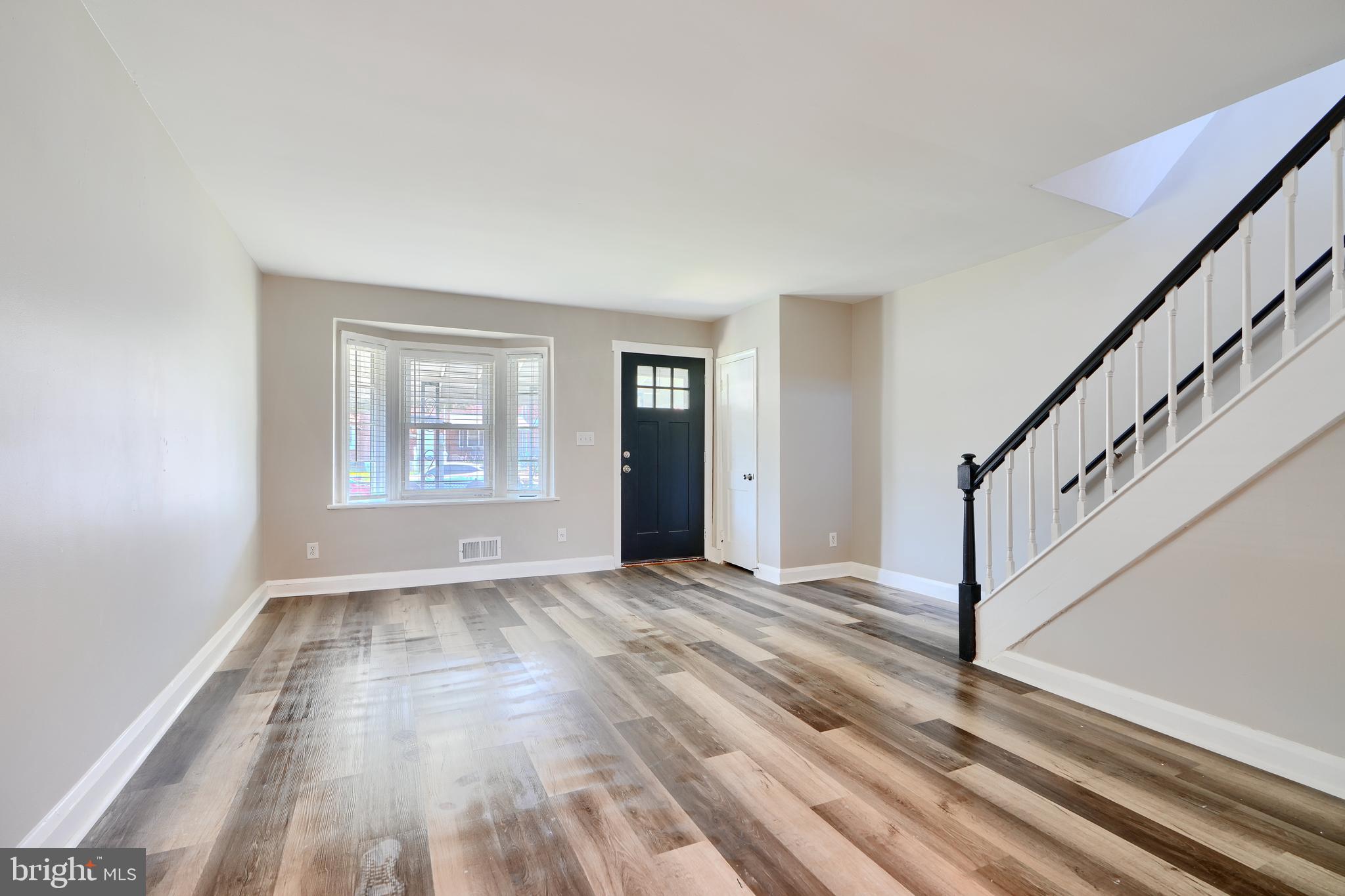 406 Torner Road Baltimore, MD 21221 - Photo 8 of 35 a view of an empty room with wooden floor and a window