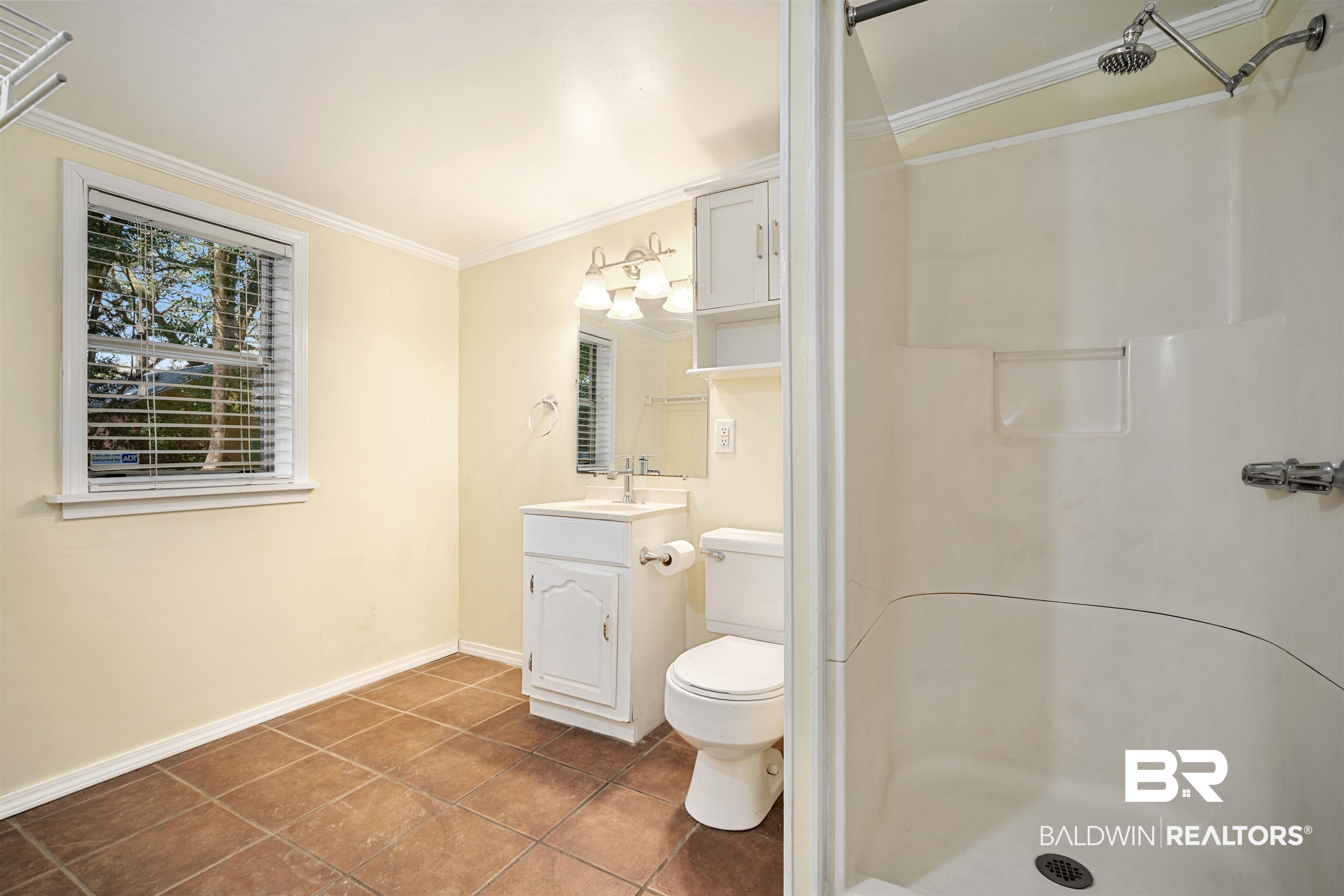 118 Mohawk Street Mobile, AL 36606 - Photo 20 of 26 Full bathroom featuring vanity, crown molding, a stall shower, and dark tile patterned floors