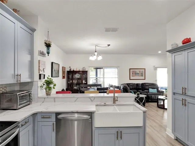 a kitchen with lots of counter top space a sink cabinets and appliances