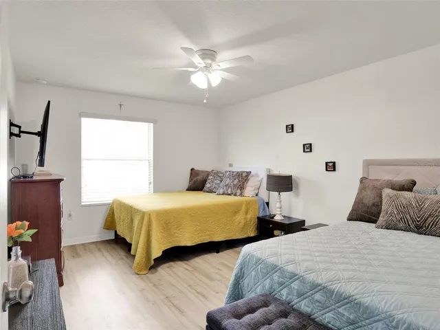 a bedroom with two beds and a chandelier
