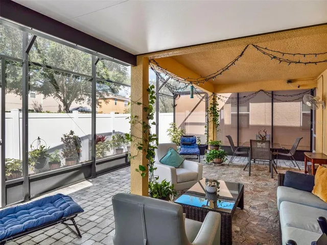 a living room with furniture and a floor to ceiling window