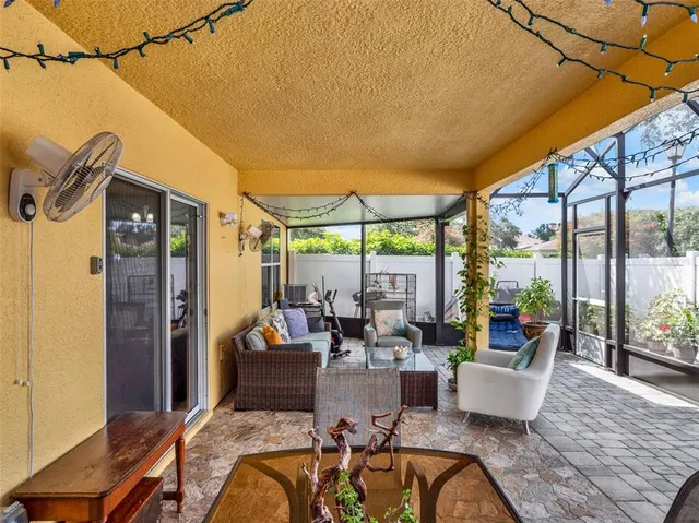 a living room with patio furniture and a fireplace