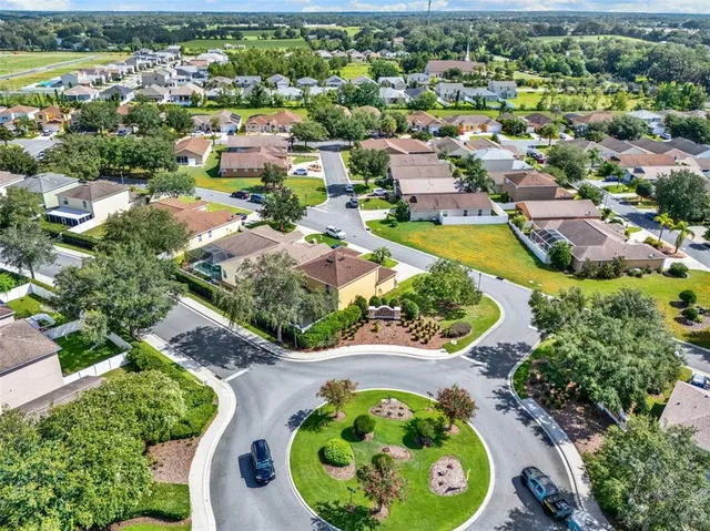 an aerial view of a house with a swimming pool yard and outdoor seating