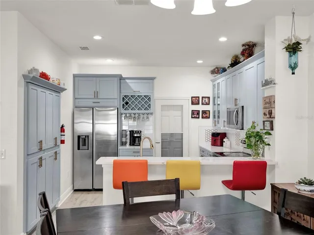 a living room with furniture wooden floor and a chandelier