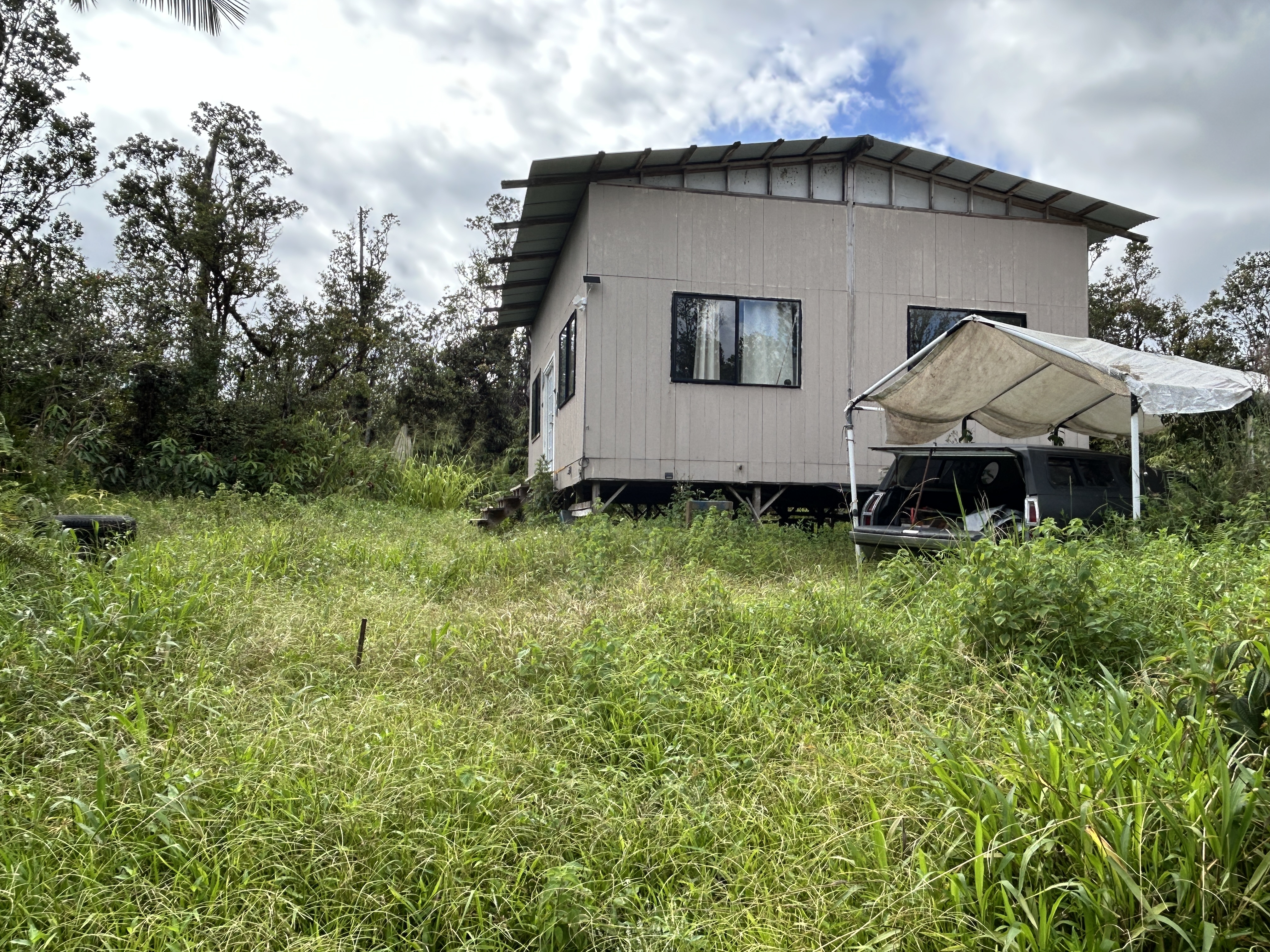 11-1834 Kolea Street Mountain View, HI 96771 - Photo 3 of 30 a front view of a house with a yard