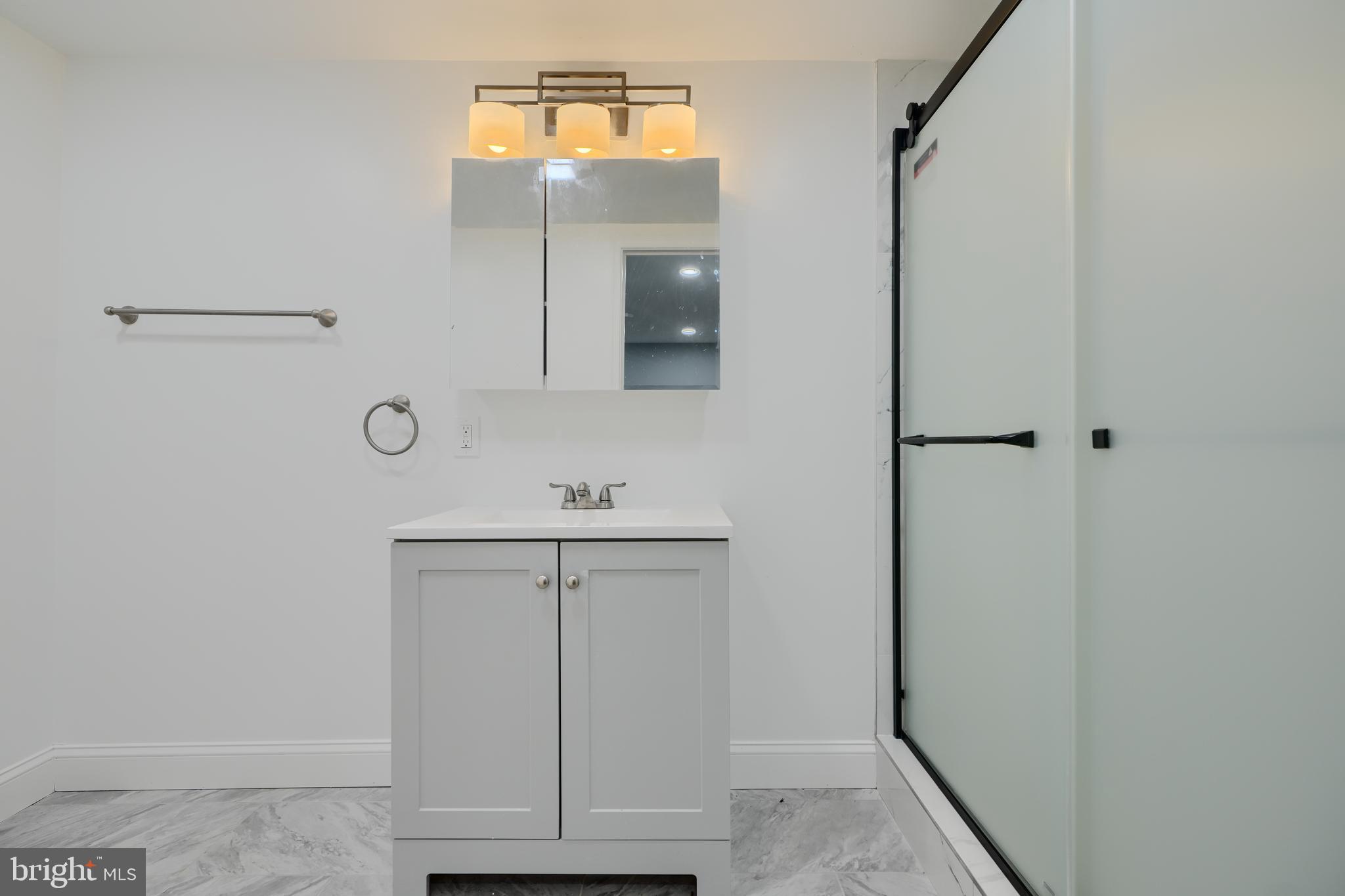 1632 Riverwood Road Baltimore, MD 21221 - Photo 17 of 32 a bathroom with a sink and a mirror