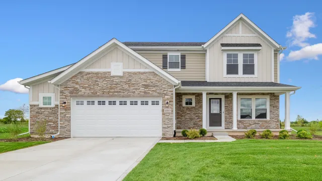 a view of house with yard and front view of a house