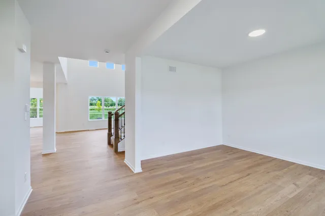 a view of an empty room and wooden floor