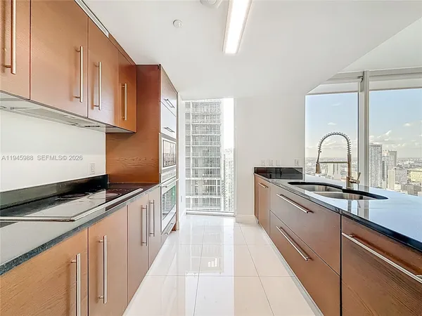 a kitchen with stainless steel appliances a sink stove and cabinets