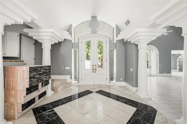 a view of a hallway with entryway windows and chandelier