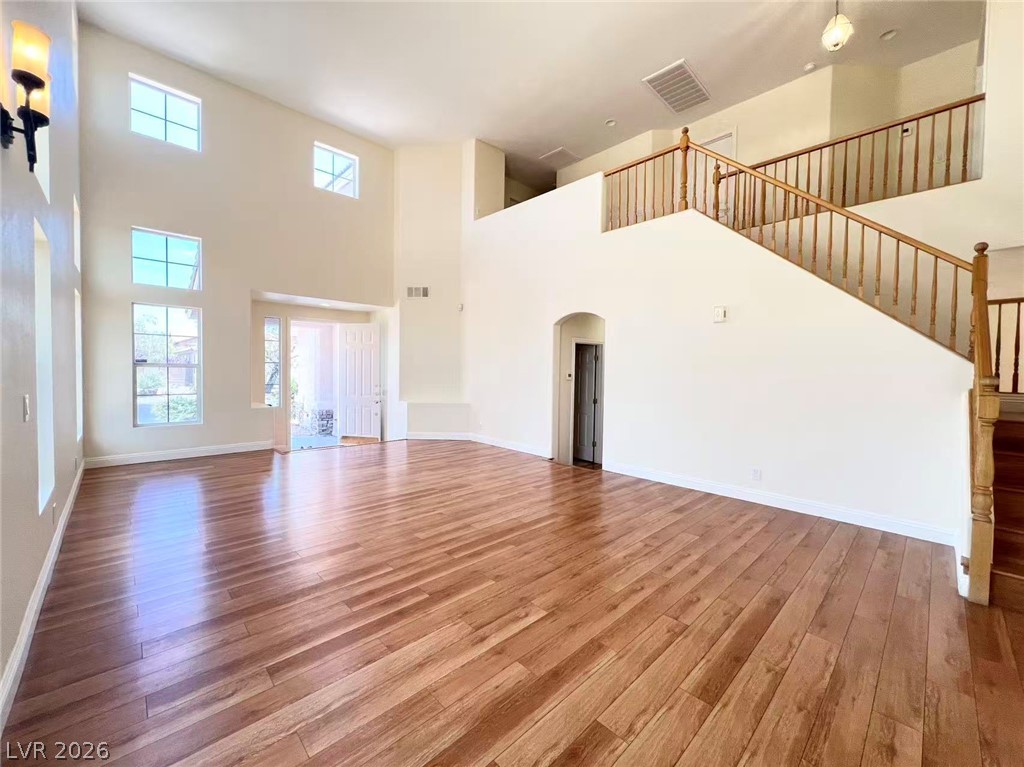 9891 Ridge Hill Avenue Las Vegas, NV 89147 - Photo 6 of 29 A grand entry with soaring ceilings and rich hardwood floors awaits.